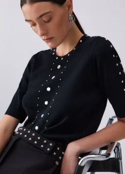Top in maglia con borchie